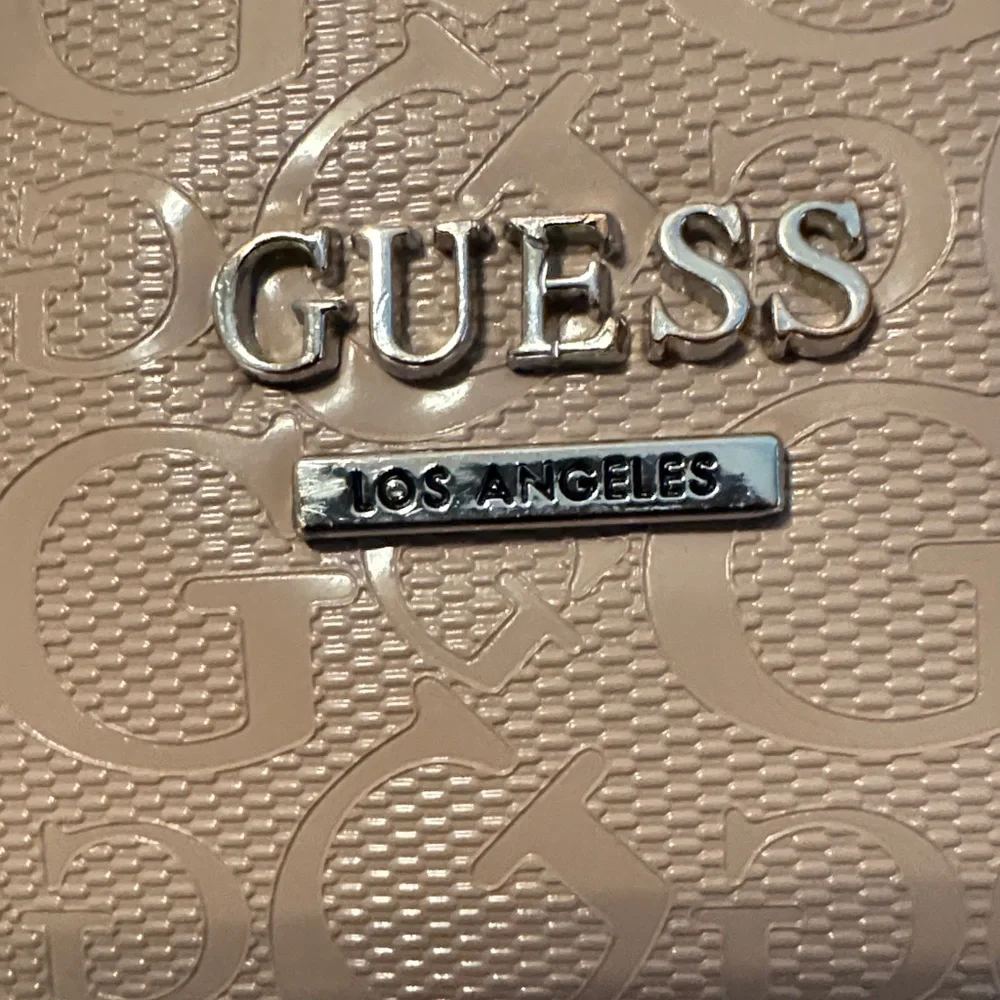 GUESS Beige Satchel Bag with crossbody strap.